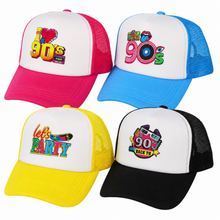 Four trucker hats arranged in a 2x2 grid on a white background, each with a different retro 90s theme graphic on the front panel: pink and red, blue and white, yellow and white, and black and white.