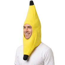 A man wearing a yellow banana headpiece hat with black tips on a white background.