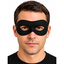 A man wearing a black eye mask, shown from the chest up against a plain white background.