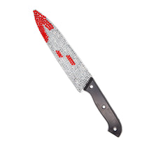 Decorative knife with a gemstone handle on a white background
