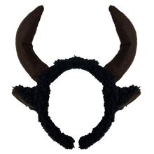 Black fuzzy horned headband with curved brown horns, shown against a plain white background.