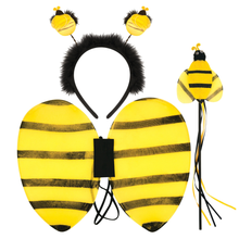 A bumblebee costume accessory set on a plain white background, including a pair of yellow and black striped wings, a black fuzzy headband with two bee head accents, and a small bee wand with wings and dangling black and yellow ribbons.