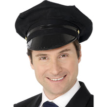 A man wearing a black captain-style Chauffeur hat with a glossy visor and a black uniform jacket over a white shirt and blue tie, photographed against a plain white background.
