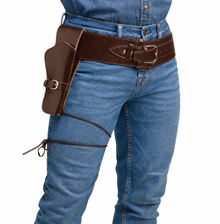 A brown leather gun holster pouch attached to a wide brown leather belt worn over blue jeans, shown on a model against a white background.
