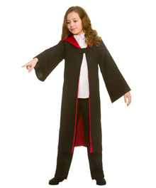 A child wearing a wizard costume consisting of a long black robe with red lining, a white shirt, and black pants, pointing to the left against a white background.