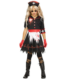 A child modeling a zombie nurse Halloween costume against a plain white background. The costume includes a black short-sleeve top with red trim and blood splatter details, a white and black skirt with red blood splatter, a black nurse hat with a red cross, red gloves, and black tights and boots.