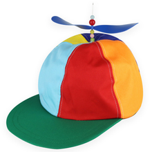 A colourful propeller cap with a green brim and a blue propeller on top, featuring red, orange, yellow, light blue, and dark blue panels on the crown.