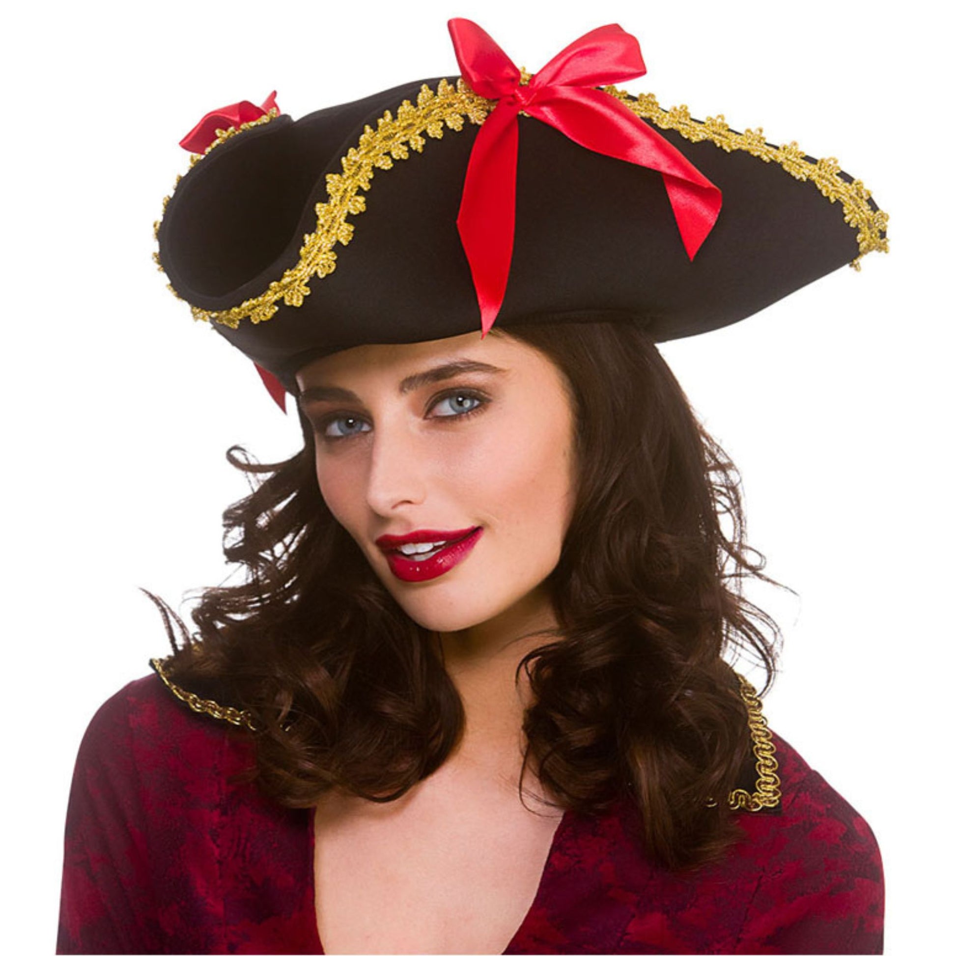 Woman wearing a pirate hat with gold trim and red ribbons on a white background