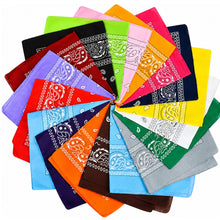 A collection of colorful bandana scarves arranged in a circular fan pattern on a white background, showcasing a wide variety of colors and traditional paisley designs.