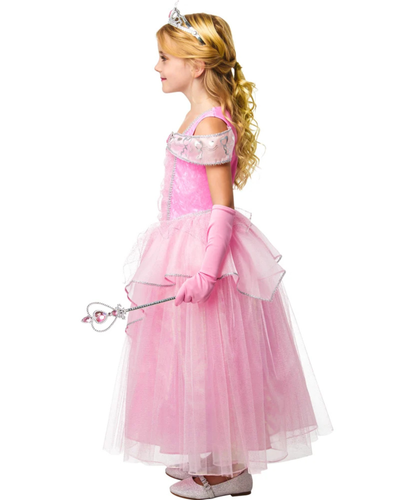 A young girl modeling a pink princess costume dress with a silver tiara and holding a silver wand, shown against a plain white background.