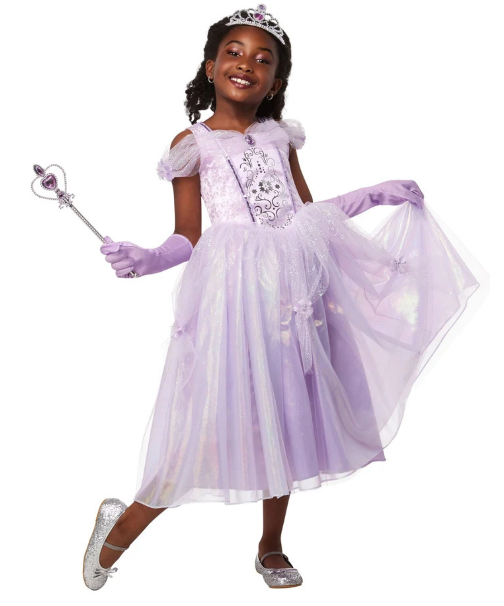 A young girl modeling a lavender princess costume dress with a tiara, holding a wand, and wearing purple gloves and silver shoes against a plain white background.