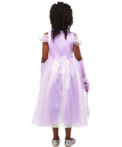 A child model shown from the back wearing a lavender princess costume dress with off-the-shoulder ruffled sleeves, matching gloves, and silver shoes against a plain white background.