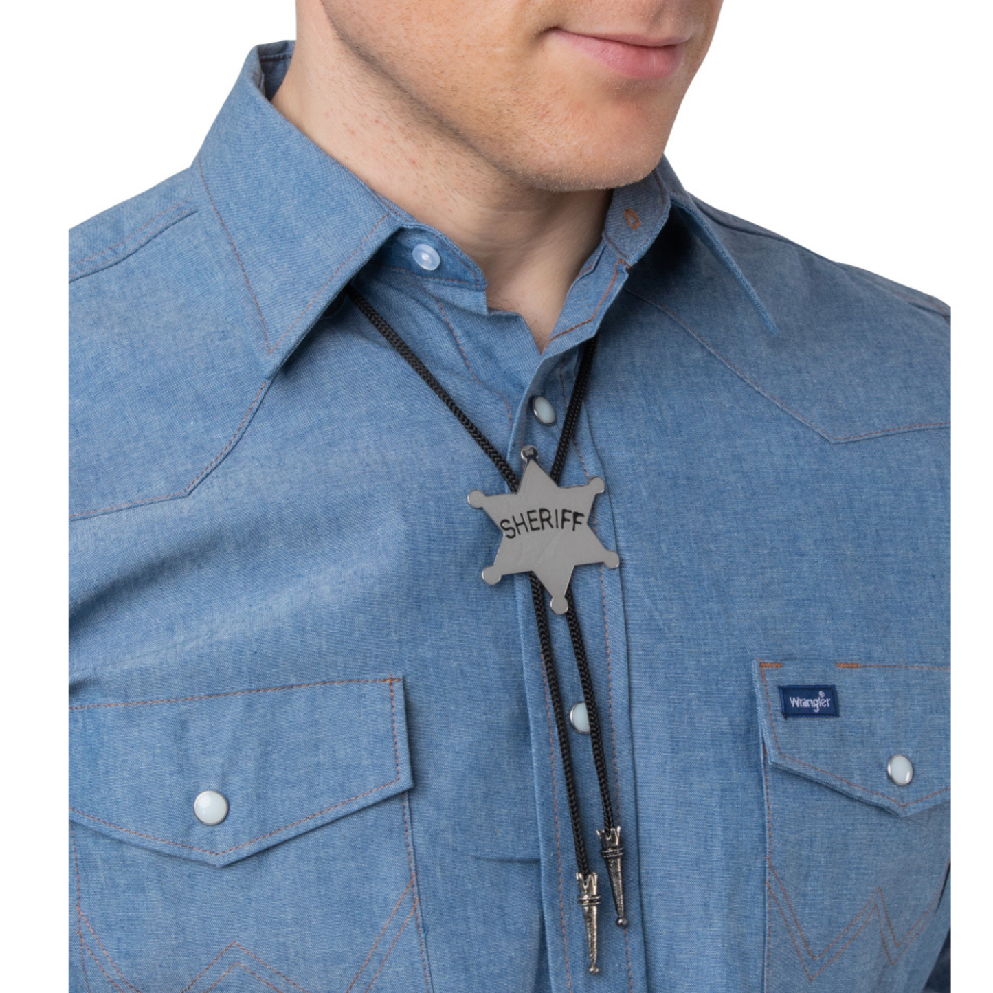 A close-up of a man wearing a blue denim sheriff's badge bolo tie necklace with a silver-toned metal badge engraved with 'SHERIFF'.