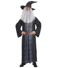 A child modeling a wizard costume consisting of a long black robe with a textured gray front panel, a brown belt, a long white beard, and a black pointed hat, set against a plain white background.
