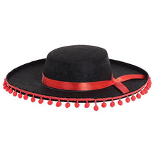 Black Spanish style hat with red ribbon and bobbles on a white background