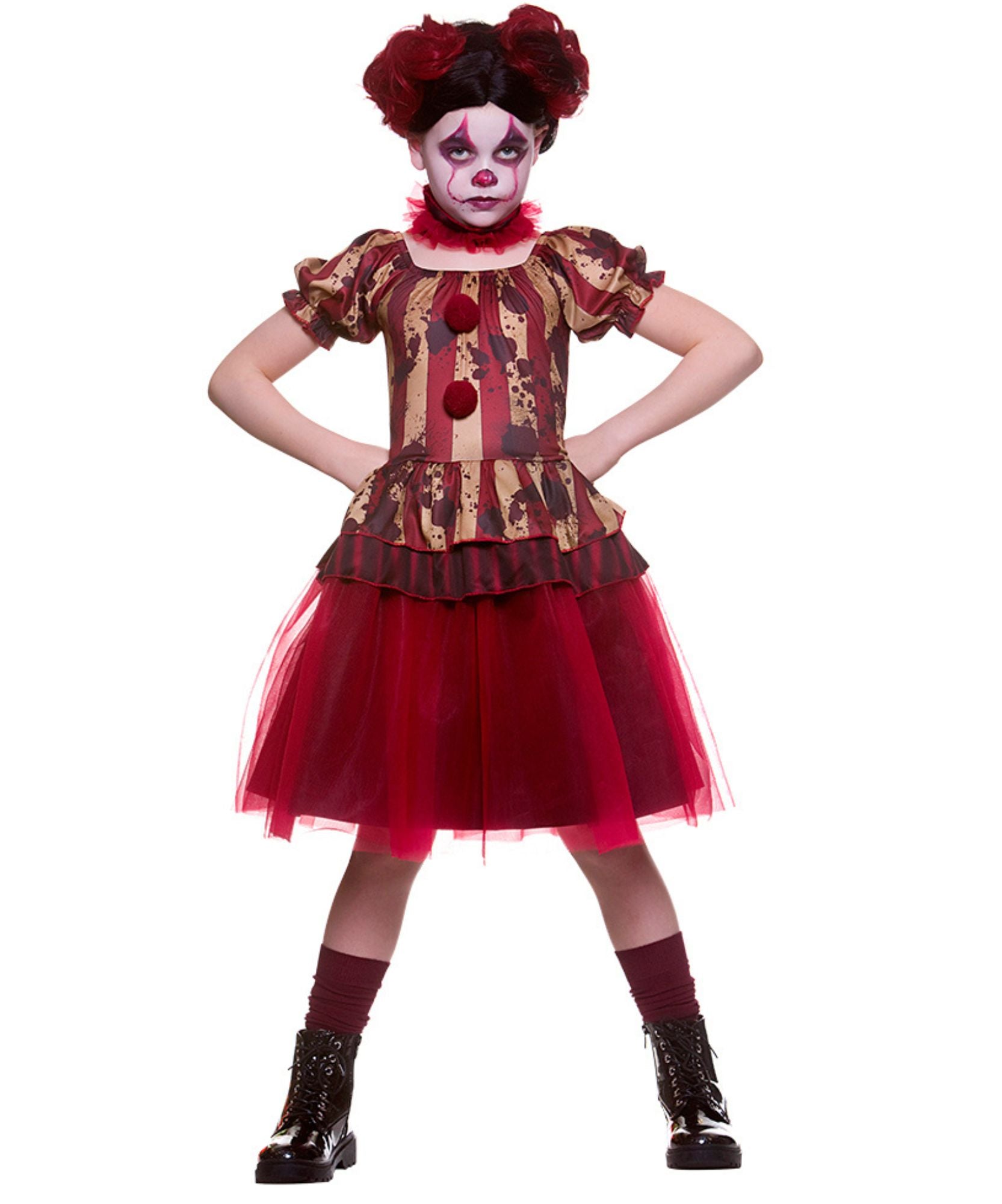 A child modeling a creepy clown costume against a plain white background. The costume features a red and gold patterned top with red pom-pom buttons, a red tulle skirt, red socks, and a red and black messy wig with white face paint.