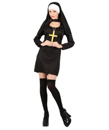 A woman modeling a black nun costume with a black dress, black veil, white head covering, black thigh-high stockings, and a gold cross pendant against a plain white background.