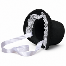 A black welsh bonnet hat with white lace trim and a long white satin ribbon, shown on a plain white background.