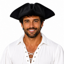 A man wearing a black pirate hat and a white lace-up shirt, photographed against a plain white background.