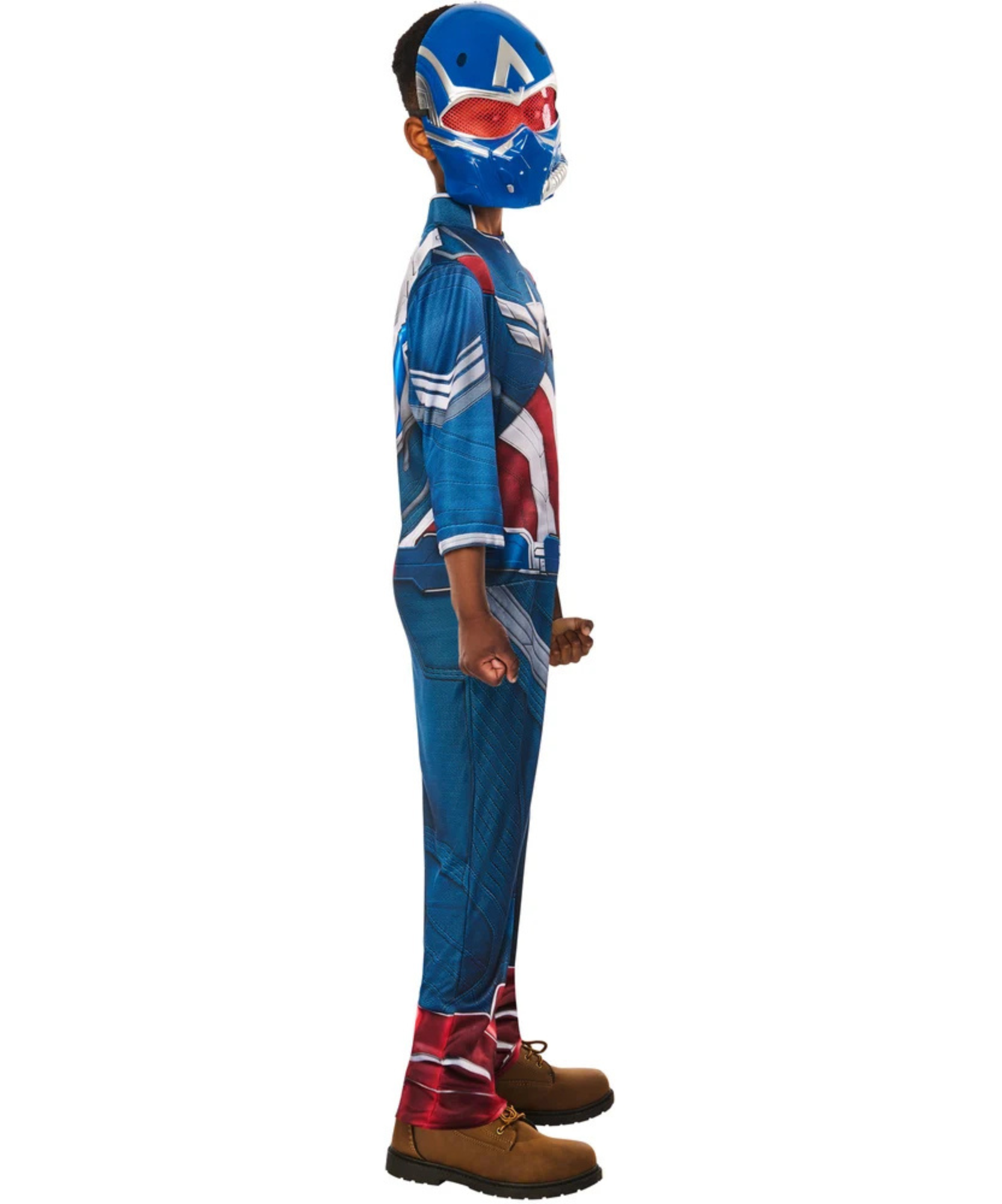 A child wearing a Captain America themed costume, featuring a blue and red printed shirt, matching pants, a blue helmet with a red eye patch, and brown shoes, shown in profile against a white background.