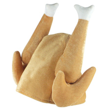 A plush hat shaped like a roasted turkey, with tan-brown body and legs and white feet, shown on a plain white background.