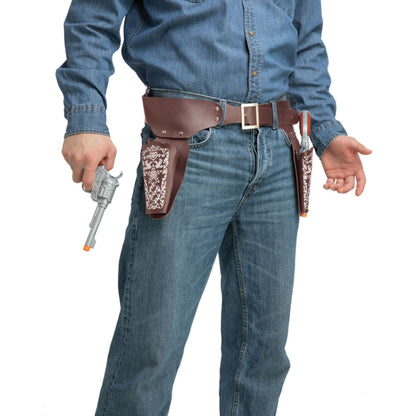A person wearing a brown leather belt holster set with patterned brown and white side panels, paired with a blue denim shirt and jeans, holding a toy revolver against a white background.