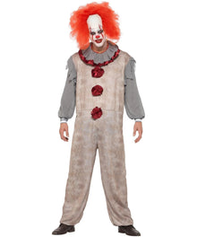A person modeling a horror clown costume against a plain white background. The costume includes a beige tattered jumpsuit with red rose accents, a gray long-sleeve shirt, a red ruffled collar, and a bright red wig.