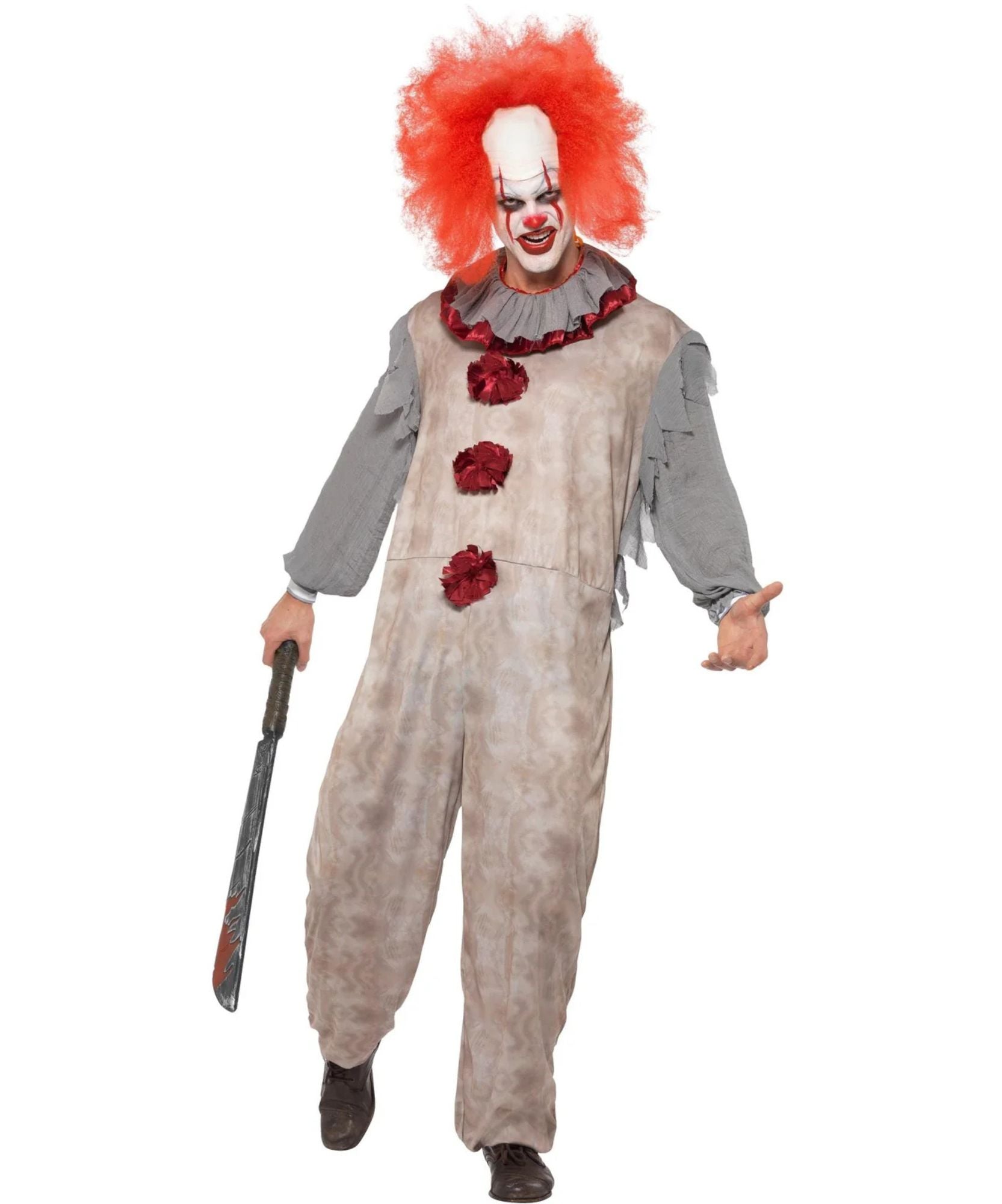 A person modeling a horror clown costume against a plain white background, holding a toy knife. The costume includes a distressed beige jumpsuit with red flower accents, a gray ruffled collar and sleeves, a red wig, and a white face mask with red clown makeup.