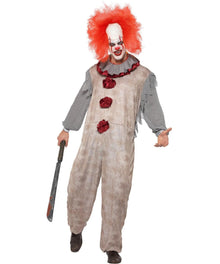 A person modeling a horror clown costume against a plain white background, holding a toy knife. The costume includes a distressed beige jumpsuit with red flower accents, a gray ruffled collar and sleeves, a red wig, and a white face mask with red clown makeup.