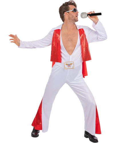 A man modeling a white Elvis Presley-style costume jumpsuit with red sequined lapels and red side panels, holding a microphone against a plain white background.