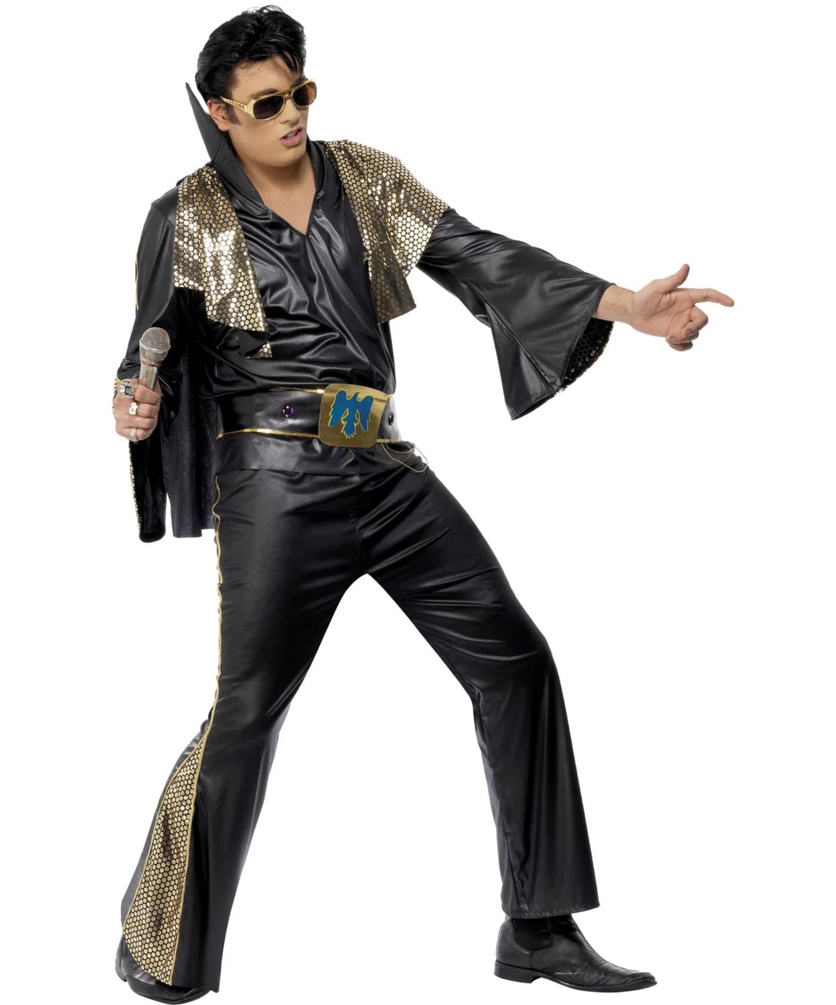 A man modeling a black Elvis-style costume with shiny gold sequined lapels and side panels, a gold belt with a blue 'PM' emblem, black flared pants, black shoes, and gold-tinted sunglasses against a plain white background.