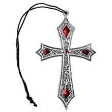 Decorative cross pendant with red gemstones on a white background