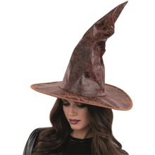 Woman wearing a brown witch hat on a white background