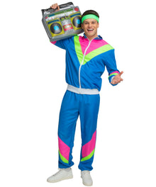 A man modeling a 1980s-style tracksuit costume, featuring a bright blue zip-up jacket and matching pants with pink and neon green color-blocked panels, a matching neon green headband, and white sneakers. He is holding a vintage boombox against a plain white background.