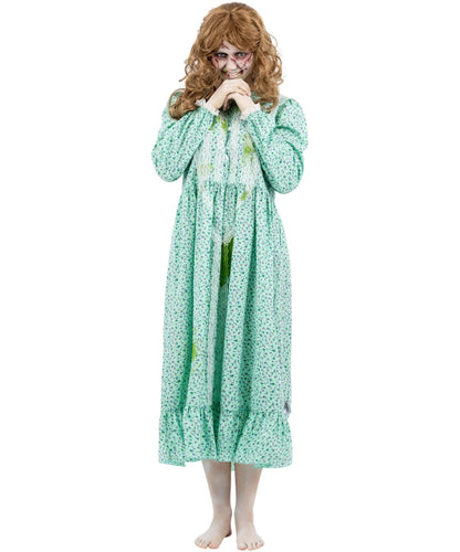 A woman modeling a long, light green nightgown with a white floral print, styled with a curly brown wig and a creepy clown face mask against a plain white background.