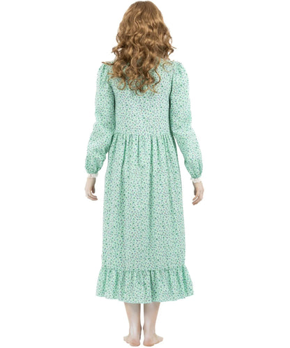 A woman shown from the back wearing a long-sleeve midi dress with a green and white floral pattern, set against a plain white background.