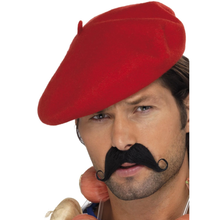 A man wearing a bright red beret-style hat and a black curled mustache, shown against a plain white background.