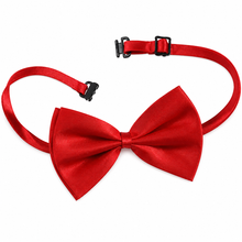 A bright red satin bow tie with an adjustable red neck strap and black plastic buckle, displayed on a clean white background.