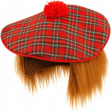 A red tartan plaid flat cap with a red pom-pom on top and long brown faux fur hanging down the front, shown against a plain white background.