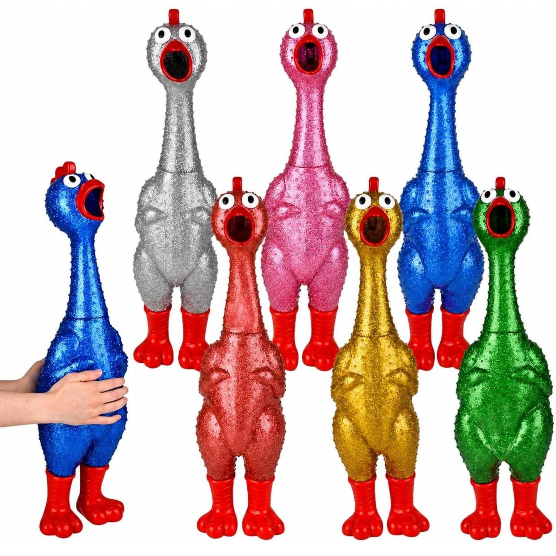 Six glittery rubber chicken toy squeakers in different colors (blue, silver, pink, blue, red, gold, green) arranged on a white background, with a human hand holding the blue one on the left.