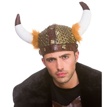 A man wearing a Viking-style horned helmet costume accessory with white horns, brown tips, gold studs, and orange-brown faux fur trim, against a plain white background.