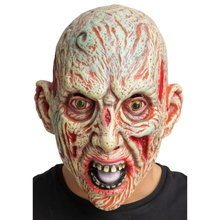 A person wearing a realistic horror mask with a bald, scarred, and grotesque face, shown against a plain white background.