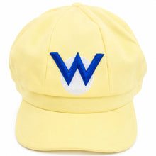 A pale yellow baseball cap featuring a blue embroidered letter 'W' on a white oval patch on the front.