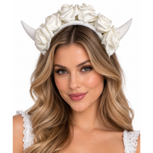A woman with long wavy blonde hair wearing a white faux-rose crown headband with two horn-like protrusions, shown against a plain white background.