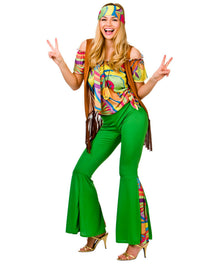 A woman modeling a retro 1960s-style costume consisting of bright green flared pants, a multicolor psychedelic off-the-shoulder top, a matching headband, and a brown fringed vest, posing against a white background.