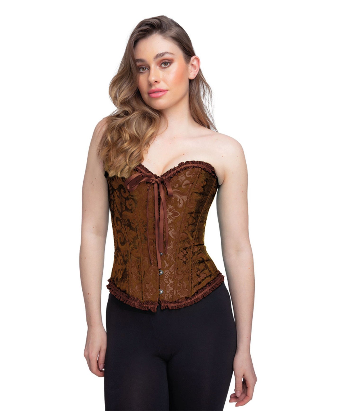 A woman modeling a brown strapless corset top with a floral jacquard pattern, front tie closure, and ruffled trim, paired with black pants against a plain white background.