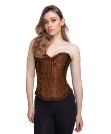 A woman modeling a brown strapless corset top with a floral jacquard pattern, front tie closure, and ruffled trim, paired with black pants against a plain white background.